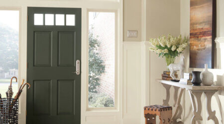 Green entry door with white interior decorative walls