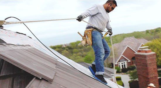 Omaha roofer installing new shingles