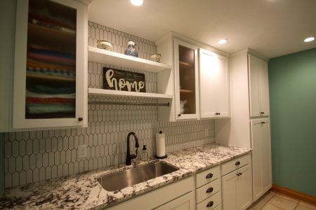 Omaha laundry room remodel with granite countertops and custom built cabinetry