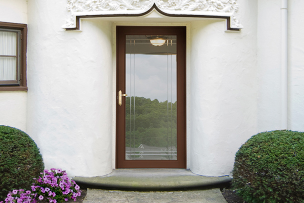 Brown storm door on white Omaha house