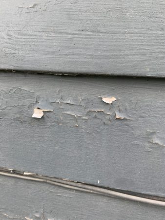 House paint with chips and cracks from hail damage in Omaha, NE