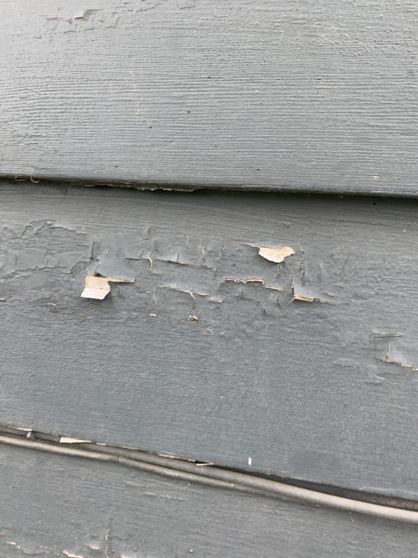 House paint with chips and cracks from hail damage in Omaha, NE