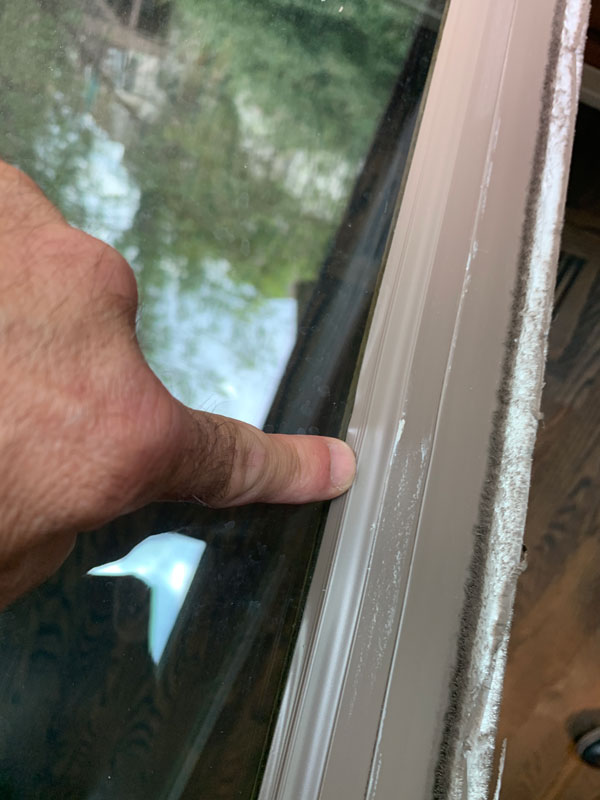Window frame with hail dent in Omaha, NE